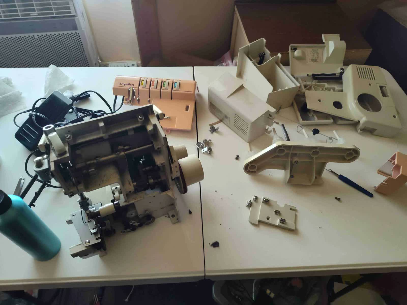 Complete sewing machine disassembly and deep cleaning at Houston Sewing Repair workshop